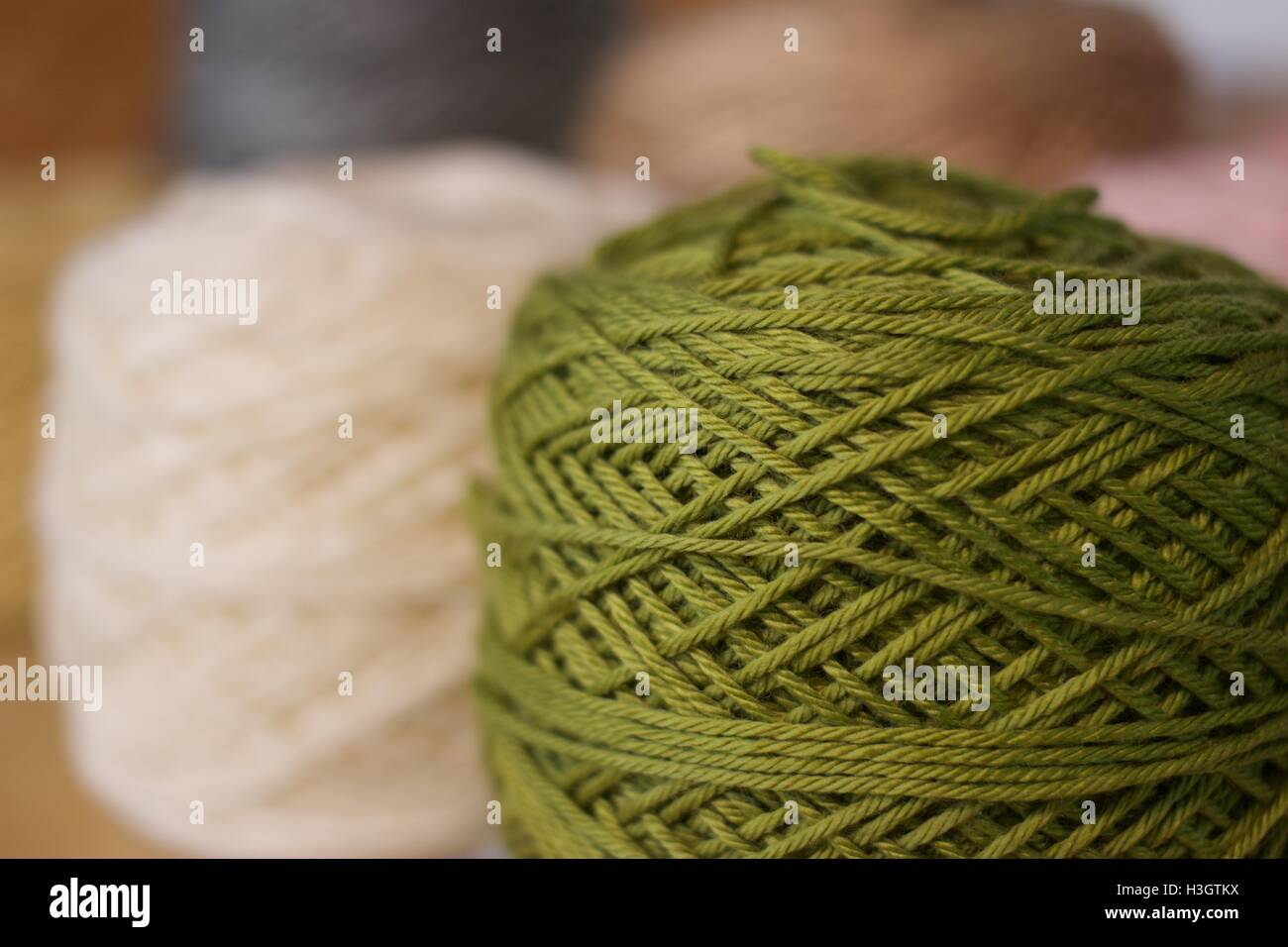 Balls of wool cotton silk Brown Pink White and Green close up Stock Photo