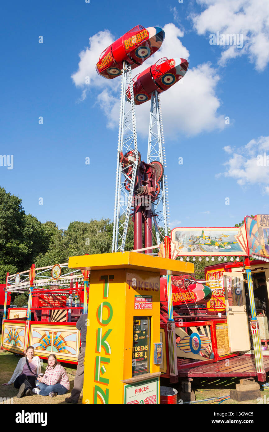 The Dive Bomber ride and token machine at Carters Steam Fair, The Green, Englefield Green, Surrey, England, United Kingdom Stock Photo