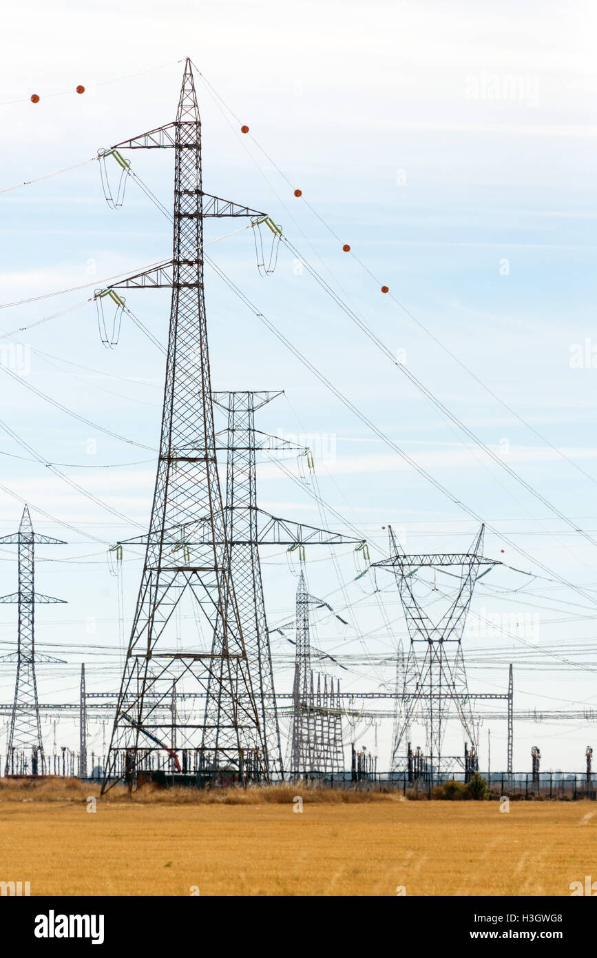 High tension towers near a power distribution station Stock Photo