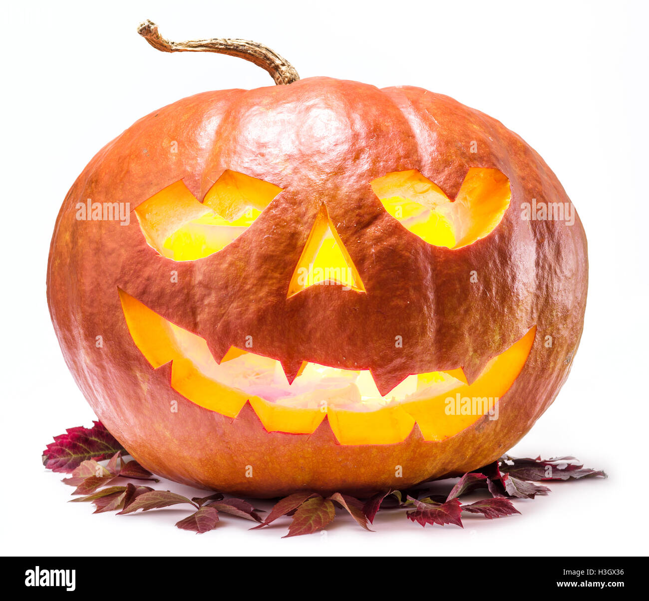 Grinning pumpkin lantern or jack-o'-lantern is one of the symbols of Halloween. Halloween attribute. Stock Photo