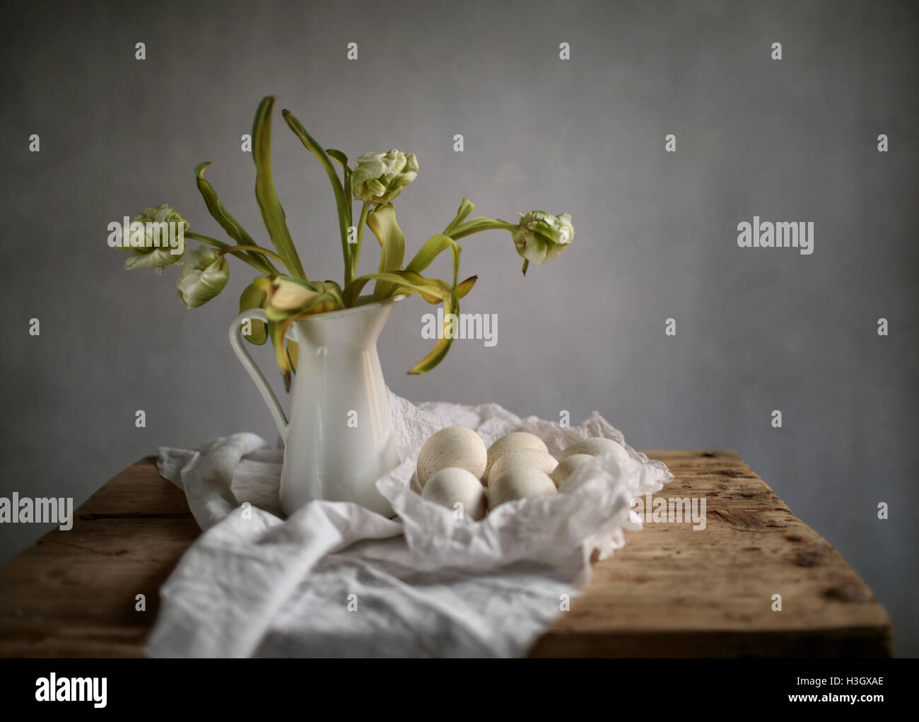 Still Life with Tulips and Eggs on wooden Table Stock Photo