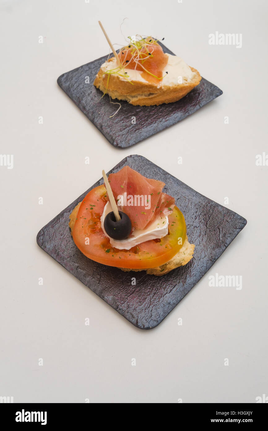 Traditional Spanish tapa, bread with garnish and toothpick Stock Photo