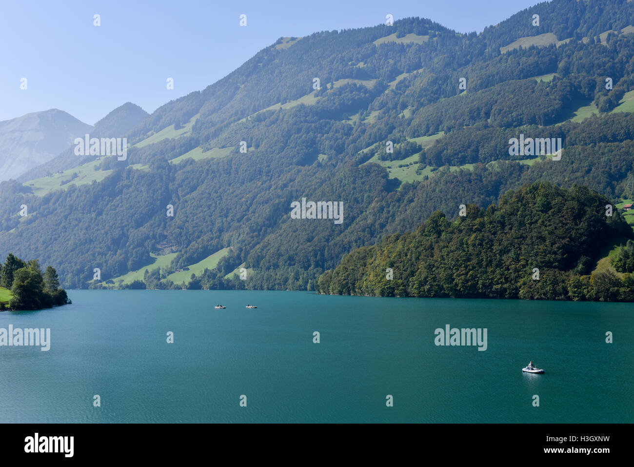 Lungern, Switzerland - 24 September 2016: People fishing on them boats at lake Lungern on Canton Obwalden in Switzerland Stock Photo