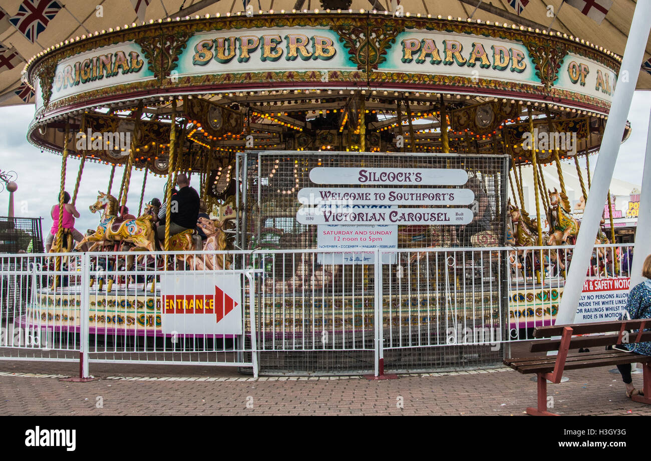 Carousel riding in the funfair Southport Lancashire  Ray  Boswell Stock Photo