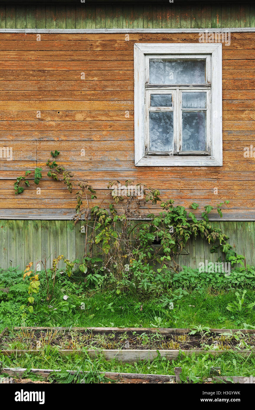 Wall of an old wooden house with windows Stock Photo - Alamy