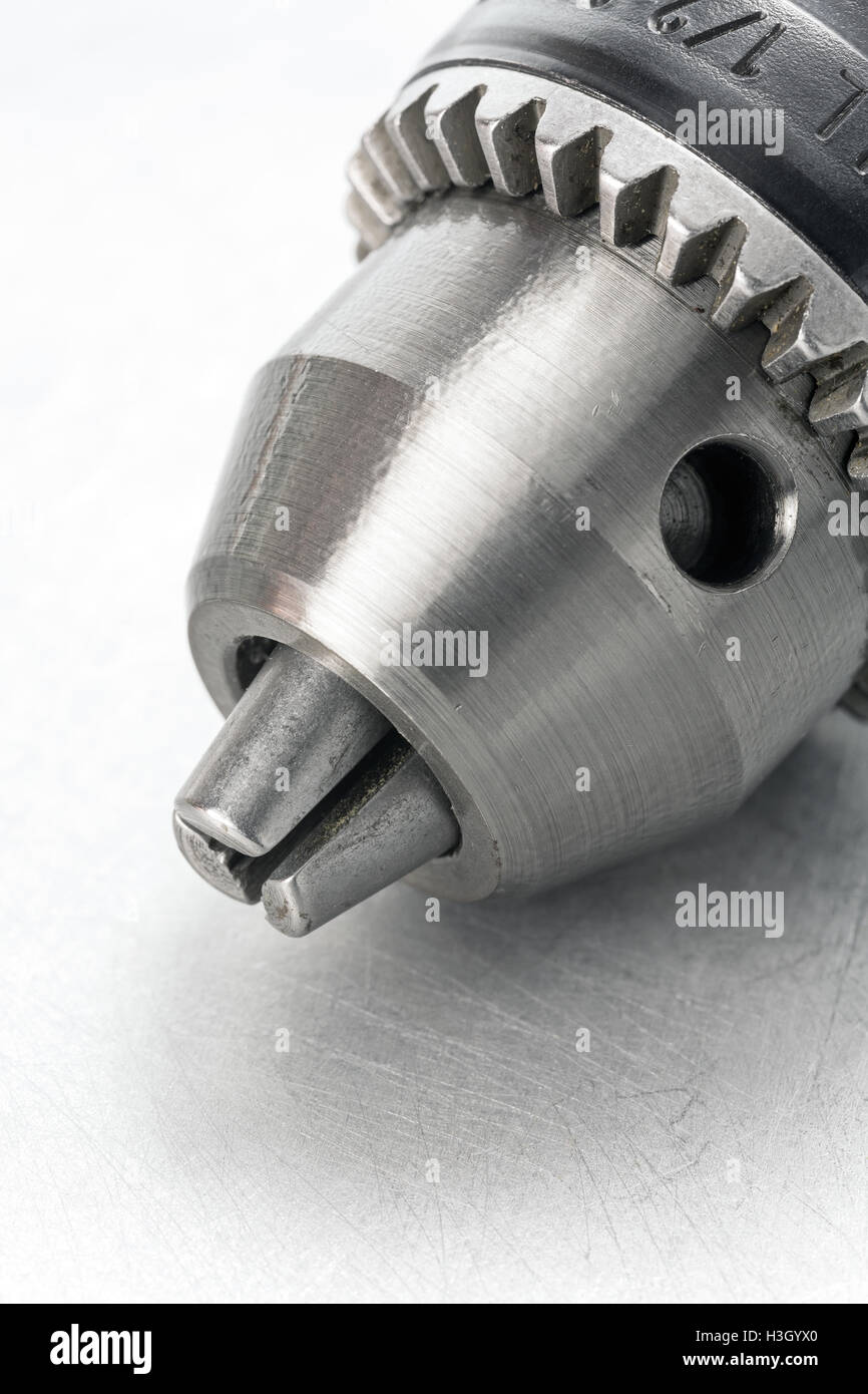 Power drill head on scratched metal background Stock Photo