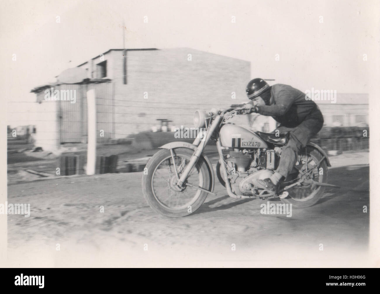 Unidentified British man racing a Matchless G3/L British Army dispatch motorbike. Photo taken in 10 Base Ordnance Depot Royal Army Ordnance Corps (RAOC) camp at Geneifa Ismailia area near the Suez Canal 1952 Stock Photo