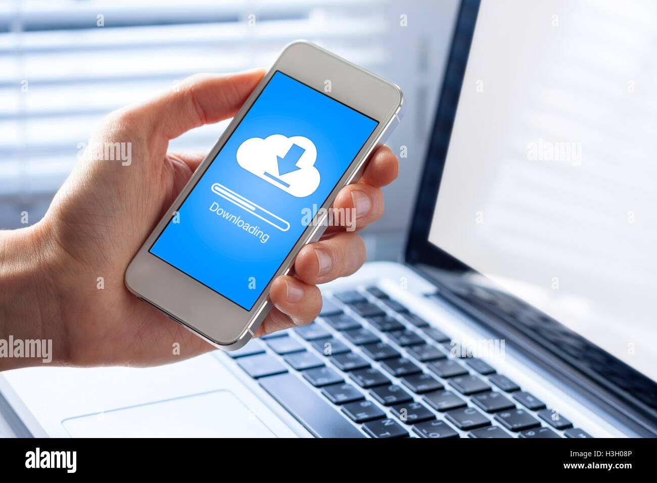 Cloud downloading on mobile phone Stock Photo