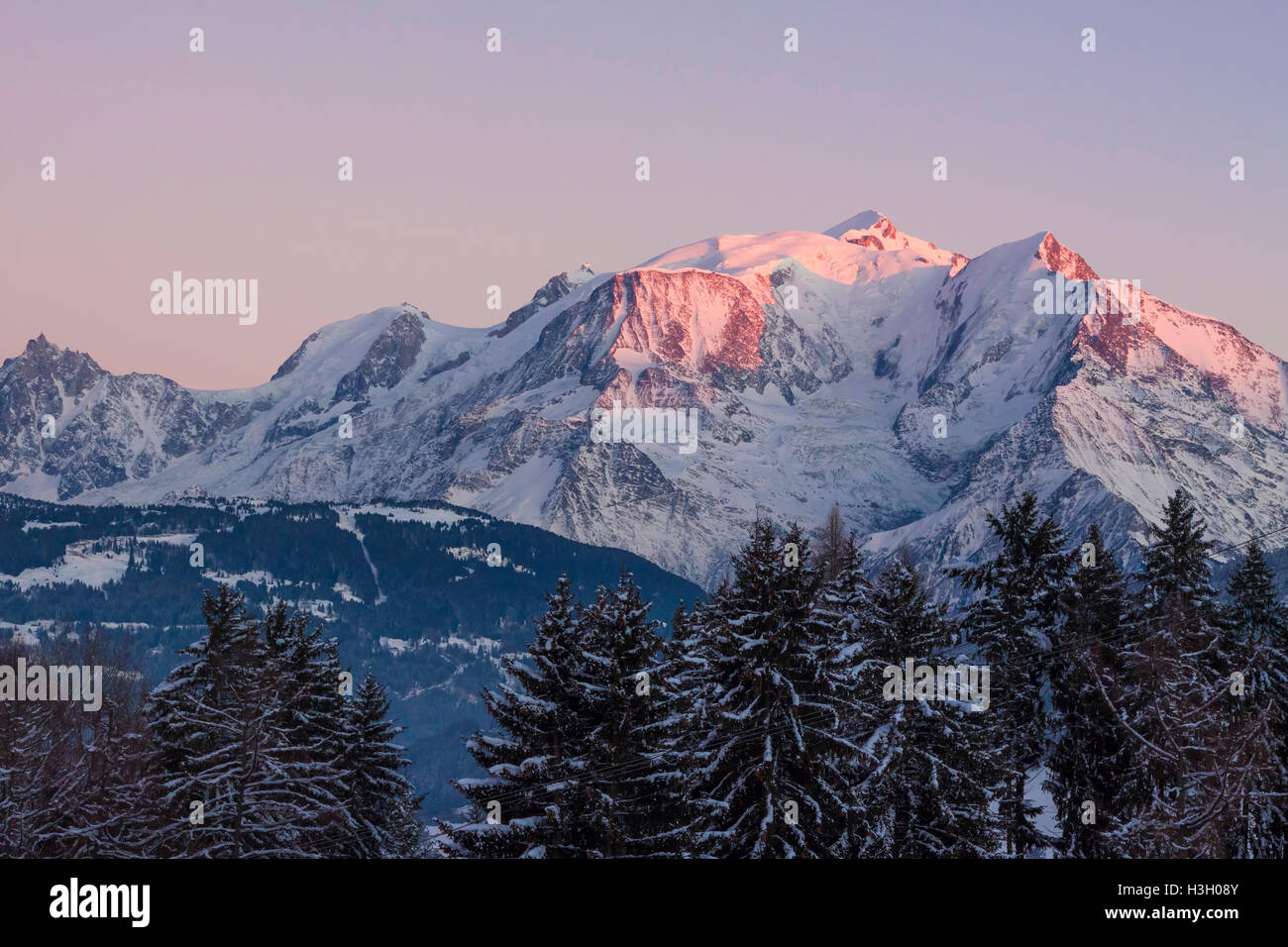 Beautiful panoramic view of Mont Blanc mountain in the Alps with orange sunset light Stock Photo