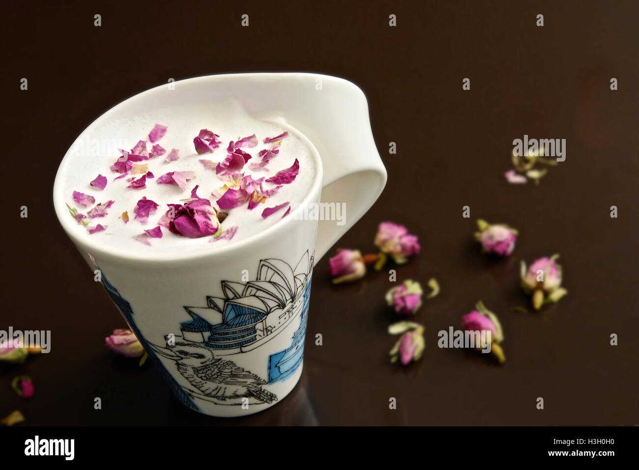 Cup of rose tea with rose bud on black background Stock Photo - Alamy