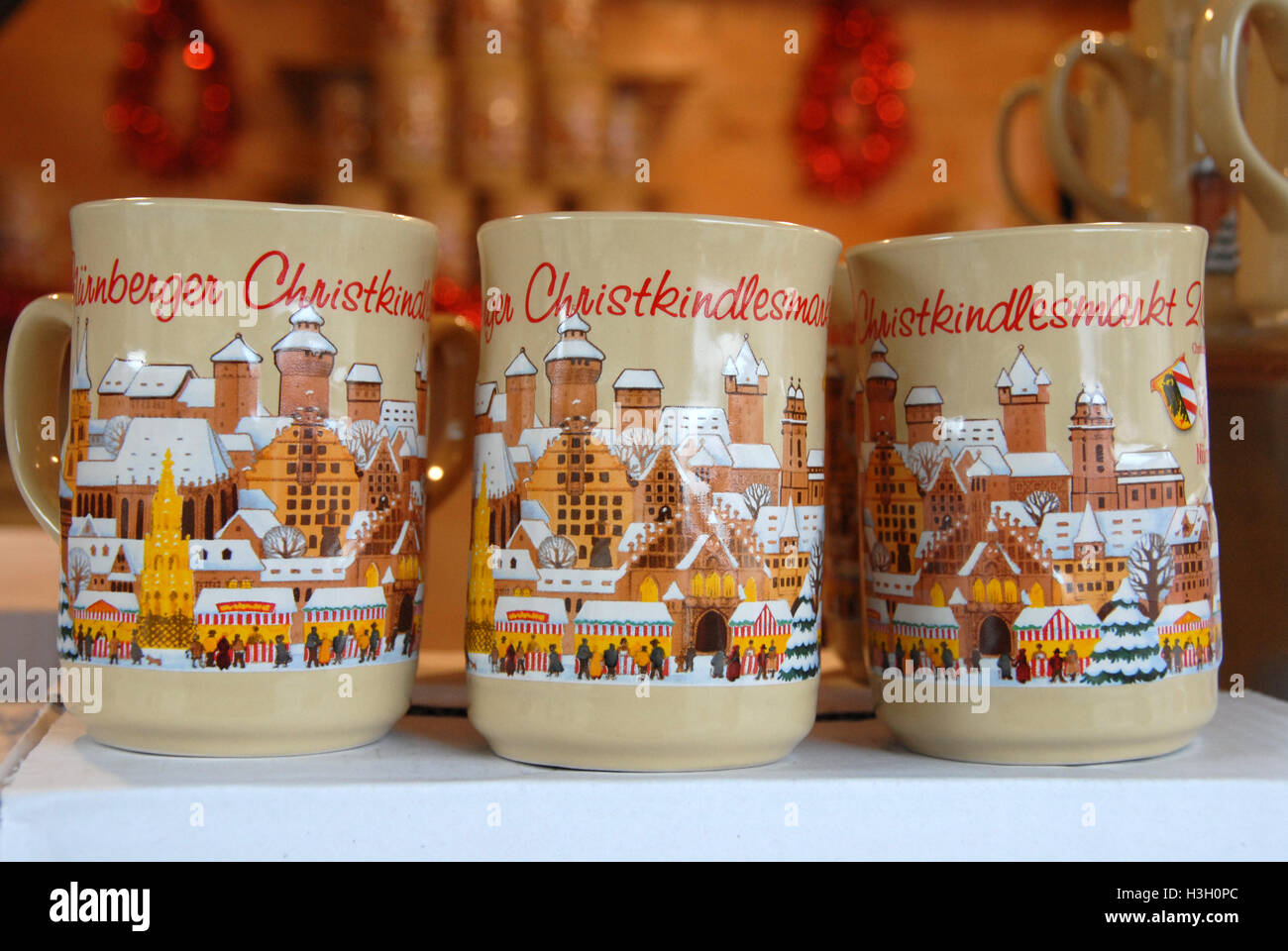 Commemorative Gluhwein (mulled wine) mugs on sale or to drink from a mulled  wine stall offering a warm-up drink for visitors a Stock Photo - Alamy