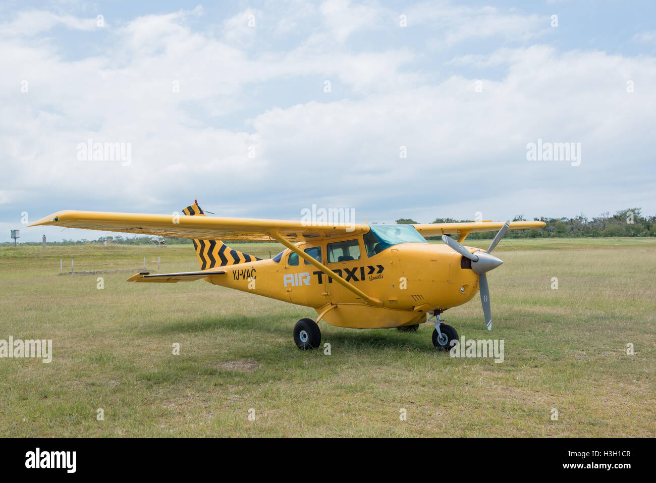 Luganvile, Vanuatu, September 27 2016: A yellow Cessna 2016 from AIR TAXI Vanutu on the airfield Stock Photo