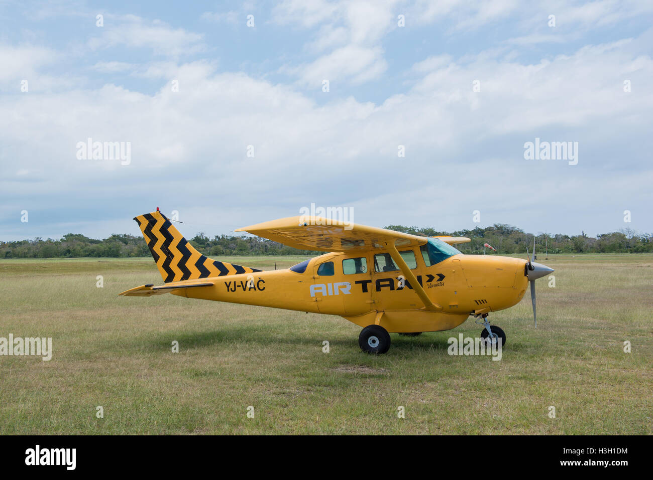 Luganvile, Vanuatu, September 27 2016: A yellow Cessna 2016 from AIR TAXI Vanutu on the airfield Stock Photo