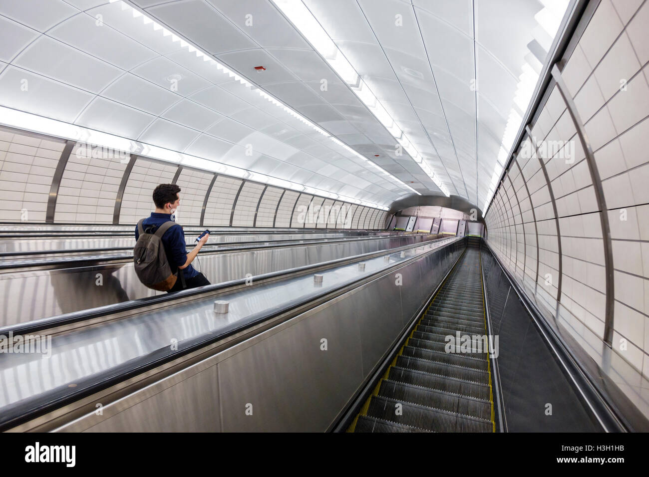 New York City,NY NYC Manhattan,Chelsea,34th Street,Hudson Yards,subway,station,MTA,escalator,adult,adults,man men male,descending,lighting,geometric s Stock Photo