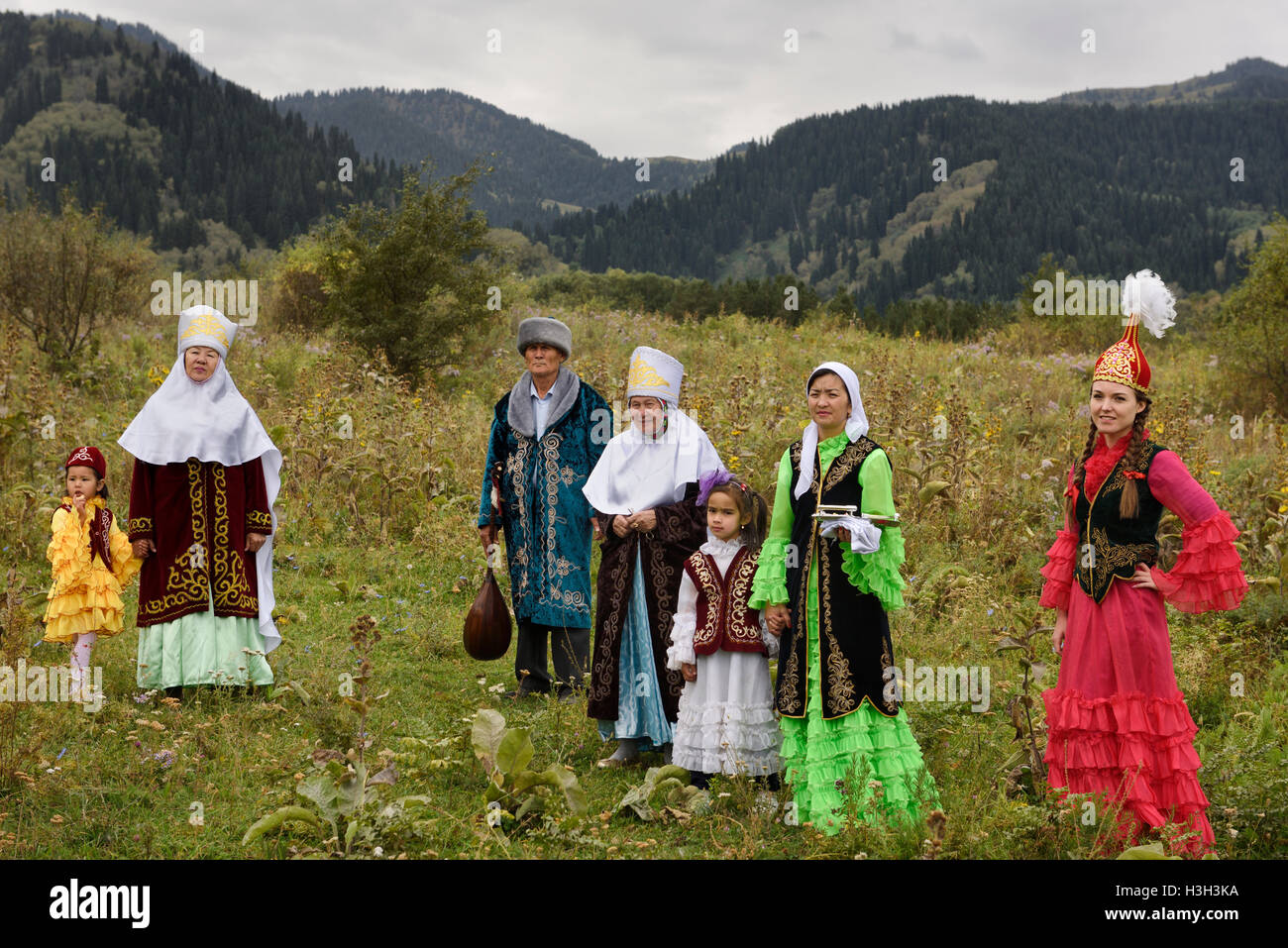 Kazakh family in traditional clothes after Tusau Kesu ceremony in field at Huns Village Kazakhstan Stock Photo