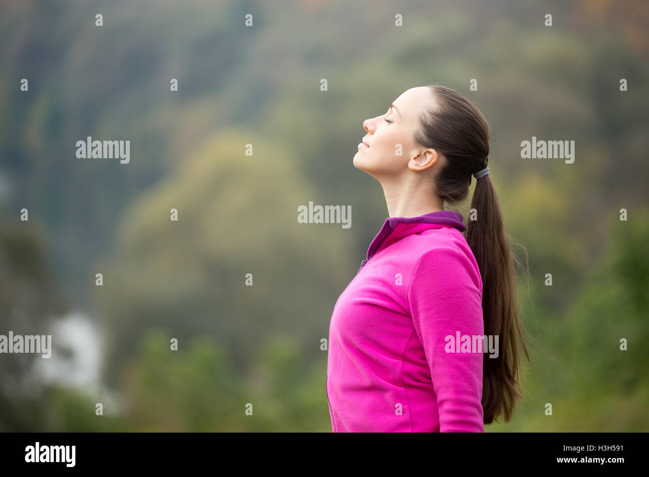 Portrait of a young woman outdoors in a sportswear, head up Stock Photo