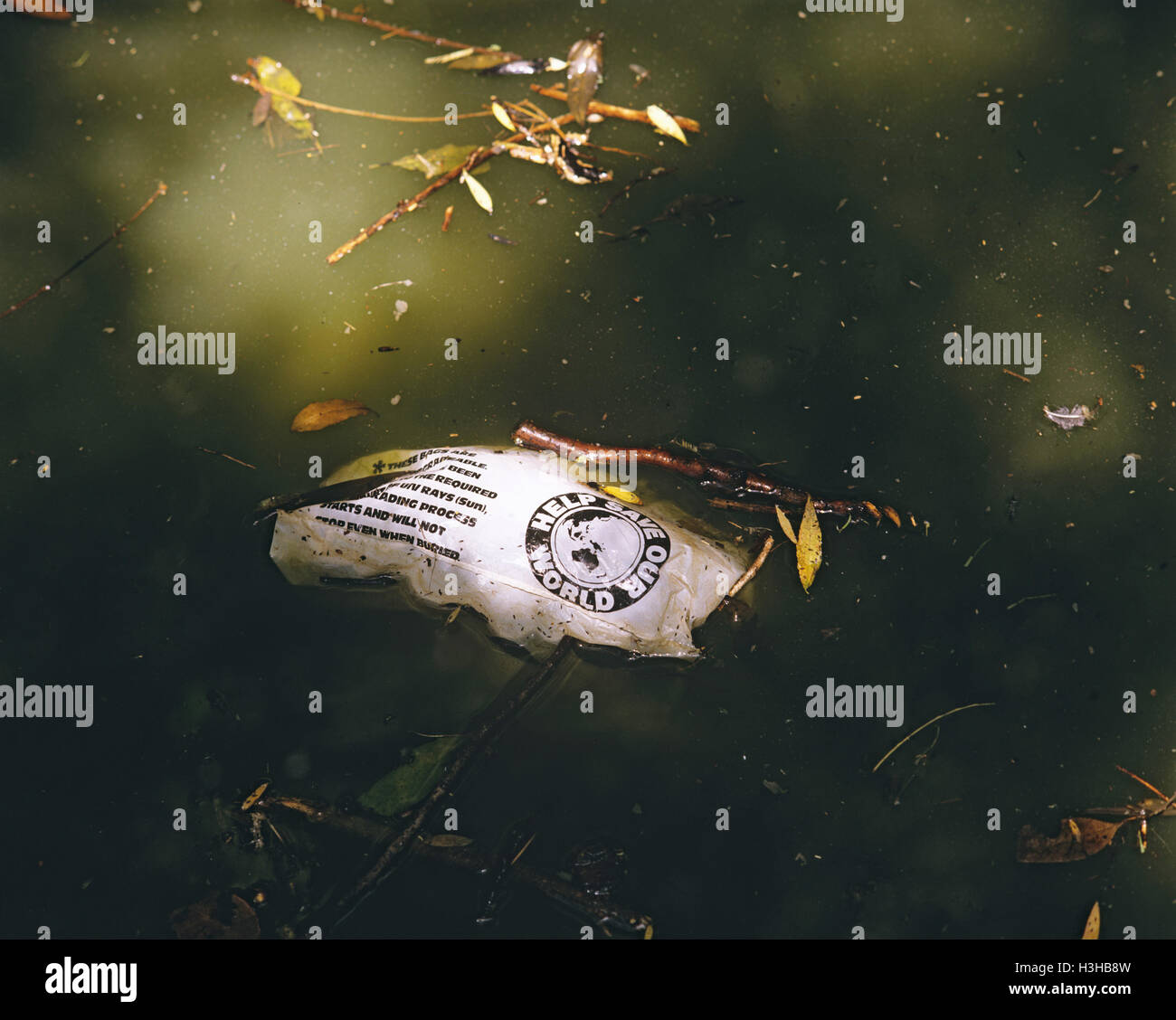 Polluted water with floating rubbish Stock Photo