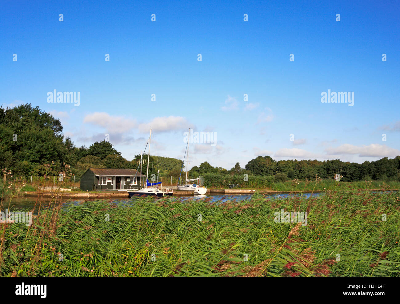 A riverside bungalow with private moorings by the River Bure on the