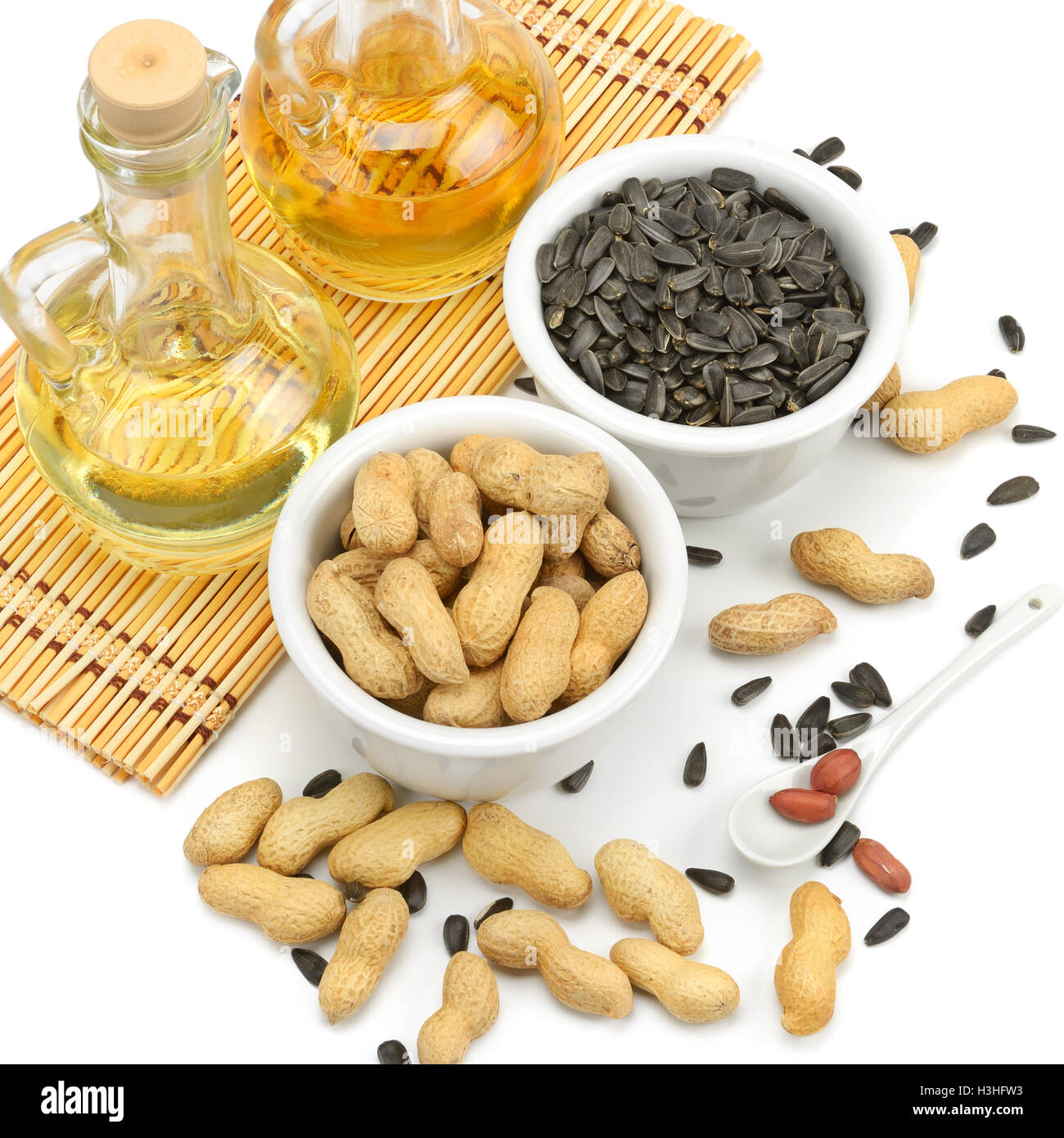 Sunflower seeds, peanuts and oil isolated on white Stock Photo Alamy