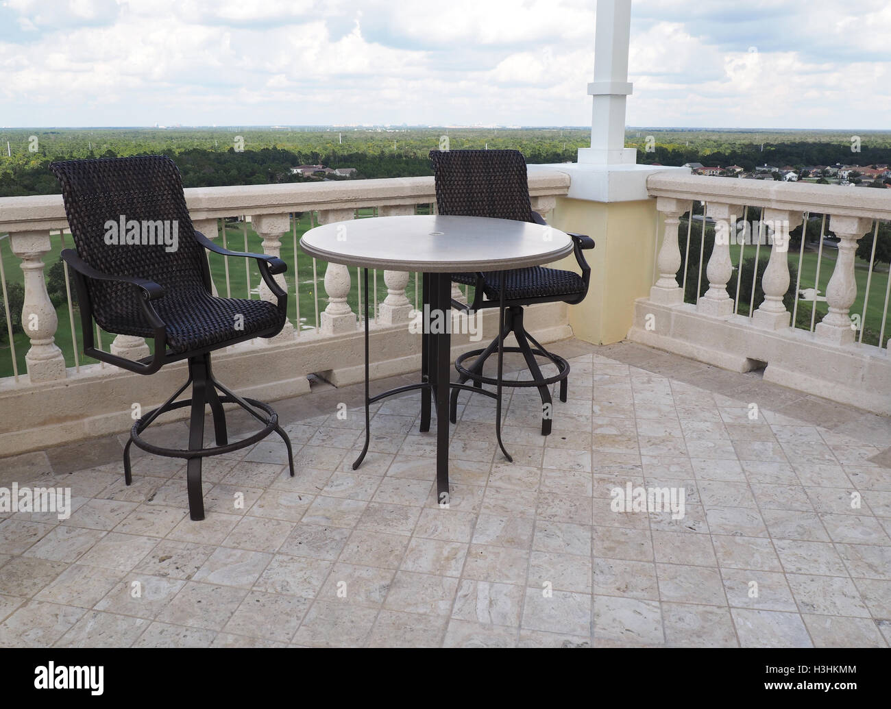 Two Chairs And A Table On A Rooftop Patio Stock Photo 122705204