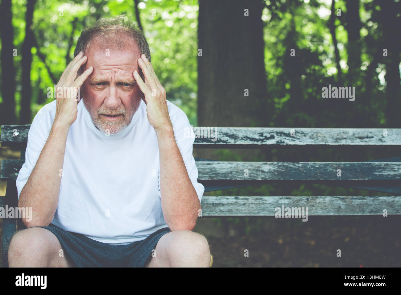 Closeup portrait, stressed older man in white shirt, hands on head with