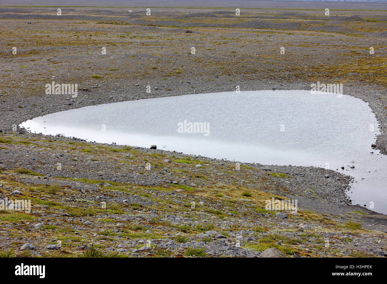 stones of end moraine and melting ice water kettle hole of Skaftafell