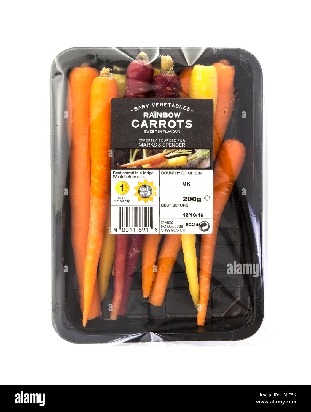 Packet of fresh Rainbow Carrots isolated on white Stock Photo