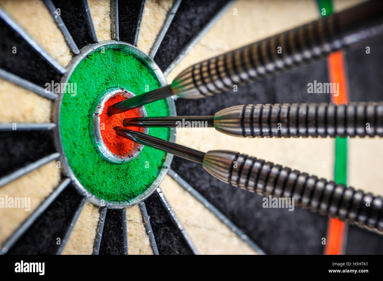 three darts in bull's eye, close up Stock Photo Alamy