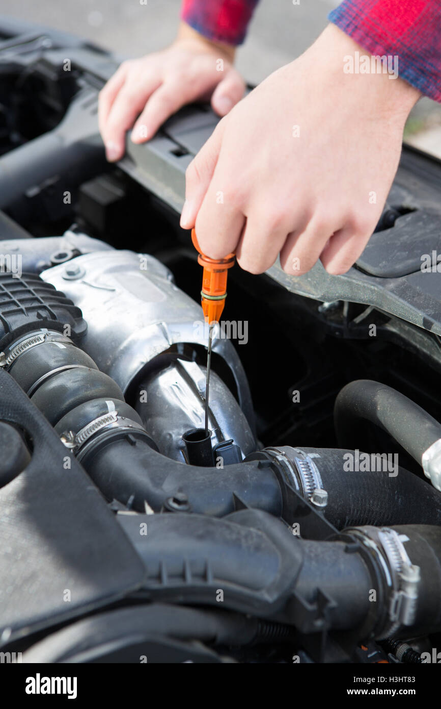 Checking Car Engine Oil Level Under Hood With Dipstick Stock Photo
