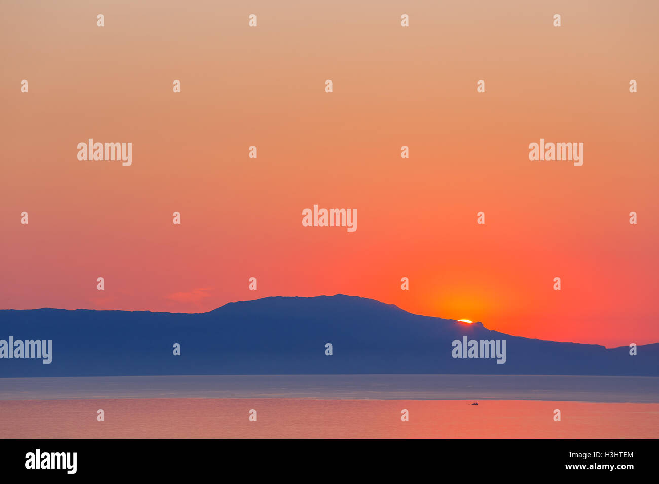 sunset over the mountain with reflection on the sea Stock Photo - Alamy