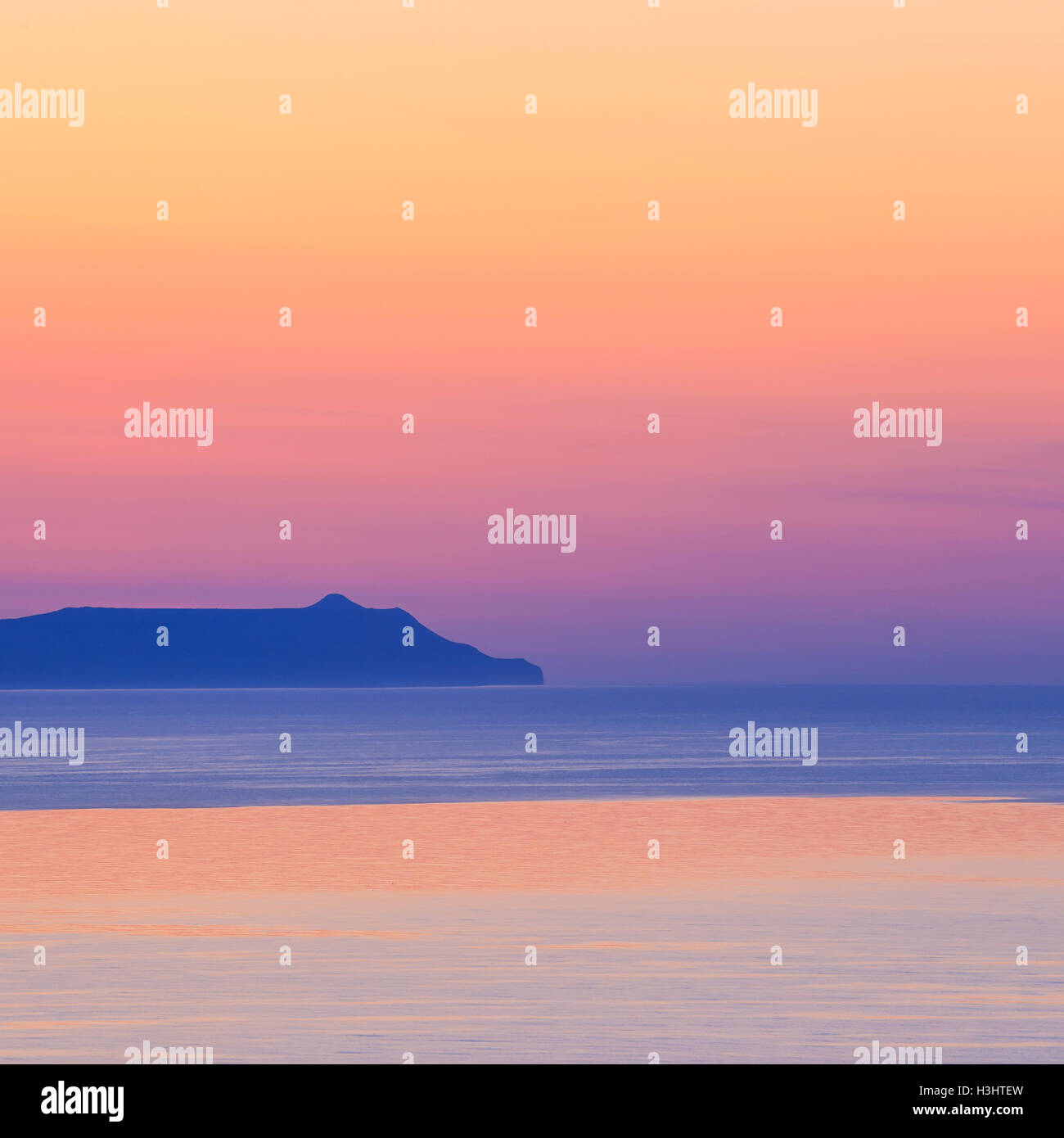 sunset over the mountain with reflection on the sea Stock Photo - Alamy