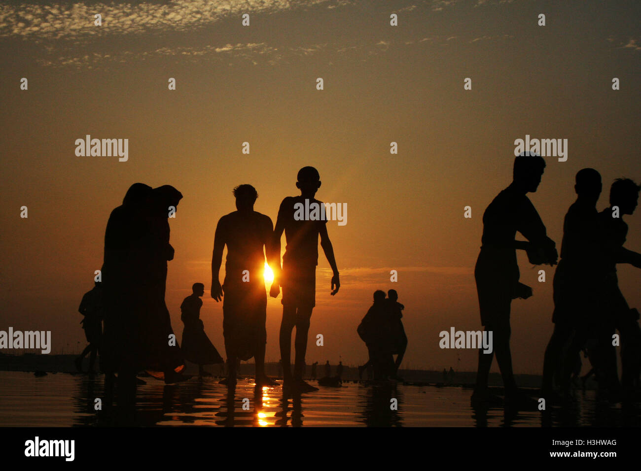 People from the Hindu community bathe at the Bay of Bengal during the Rash Mela Stock Photo