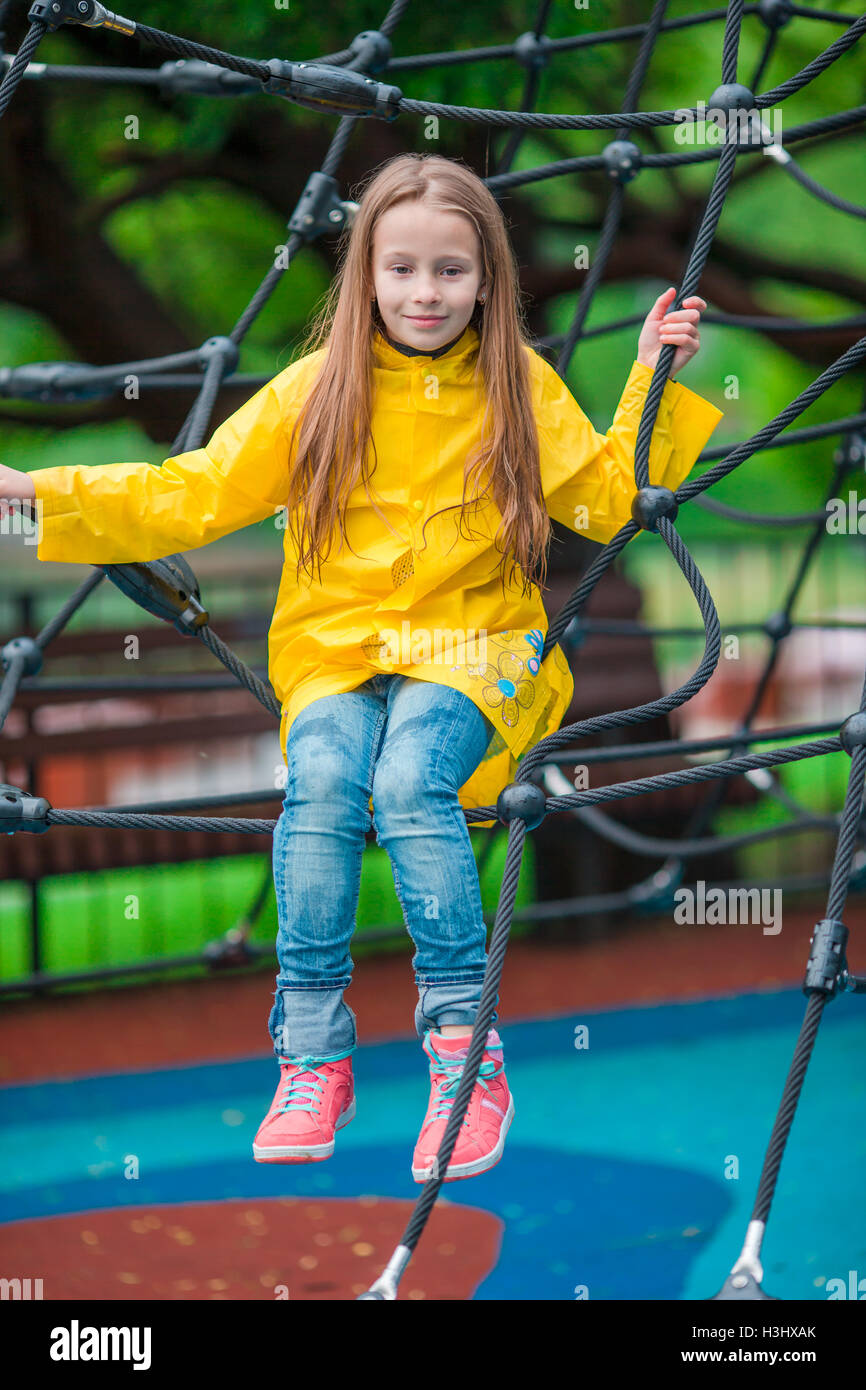 Happy little girl playing on outdoor playground in autumn day Stock ...