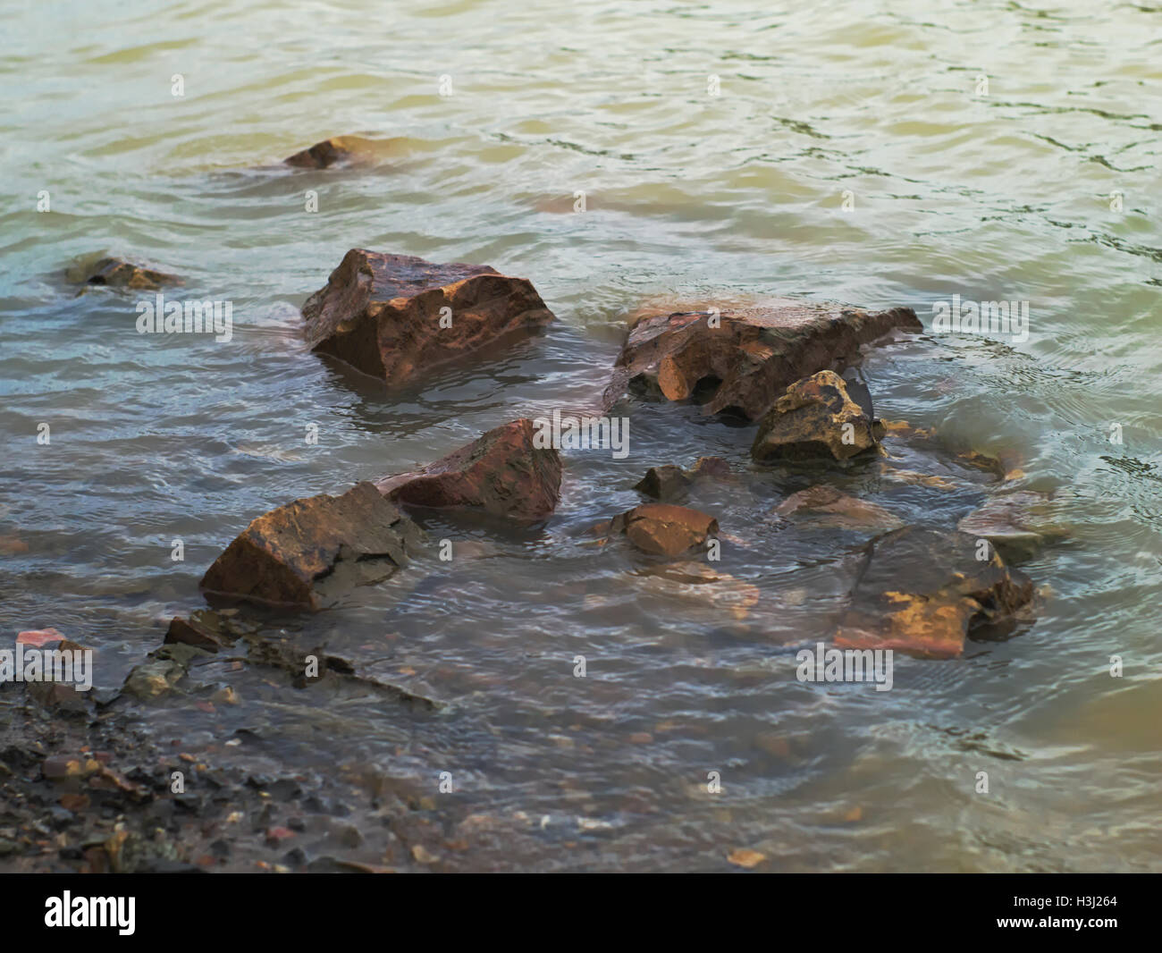 big brown stones and pebbles in the river Stock Photo