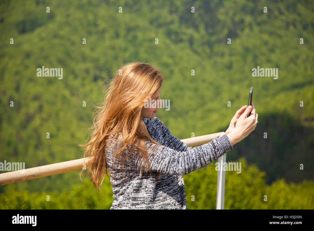 Young woman taking photos of nature Stock Photo - Alamy