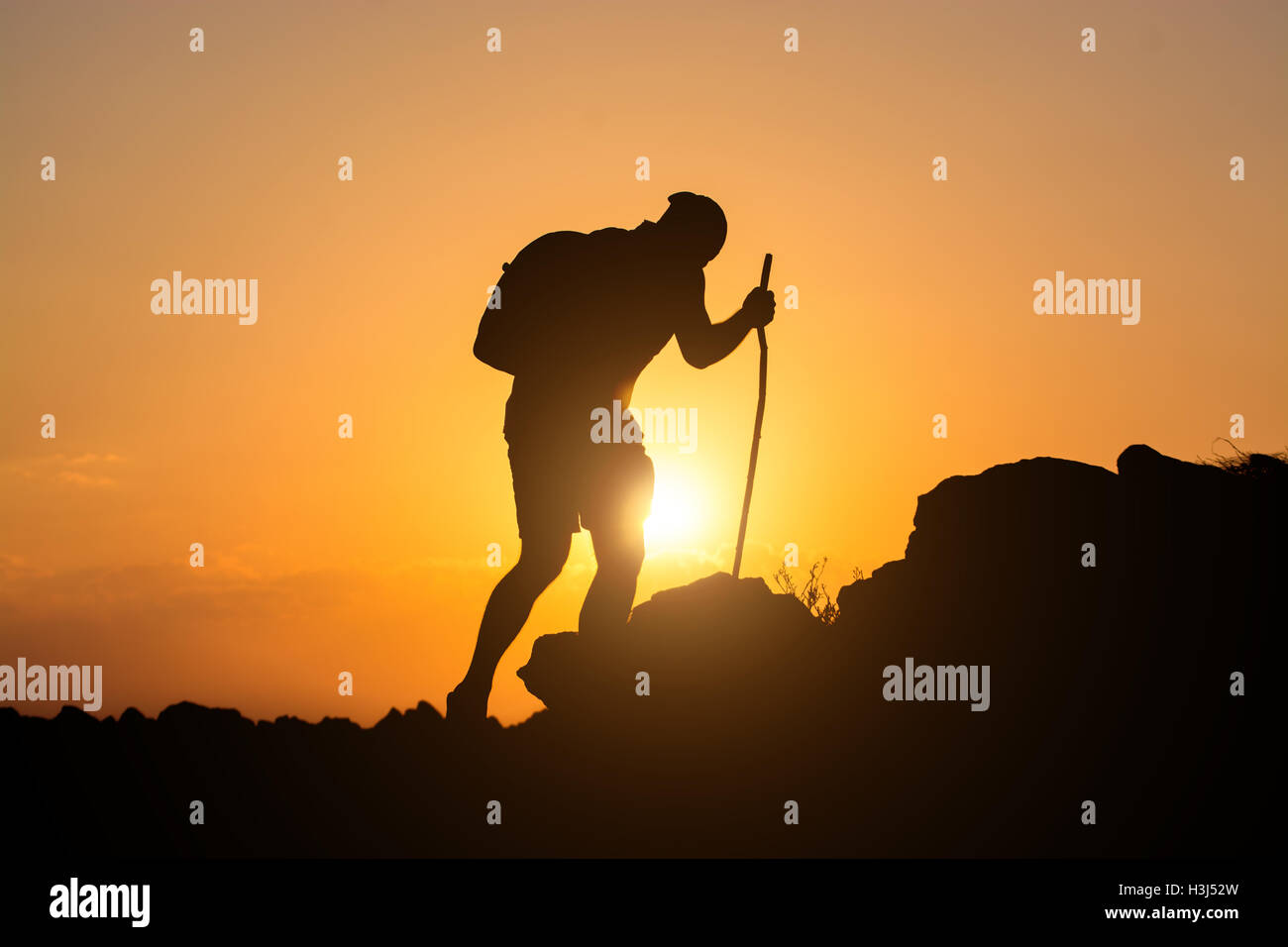 Rock climber ascending the mountain Stock Photo