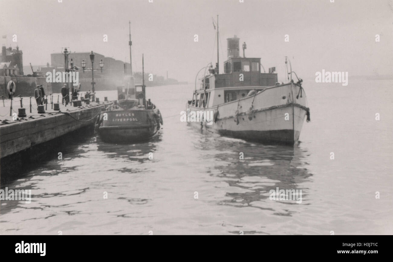 Customs and Pilot cutters at Pier Head Liverpool docks photographed in 1949.  These boats would sail out to cargo ships in the Mersey estuary and carry out customs and health inspections or deliver pilots to guide vessels in to port. Albert dock buildings are in the distance. Stock Photo