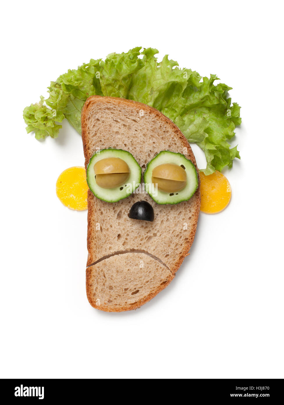 Halloween zombie made of bread and vegetables on white background Stock Photo