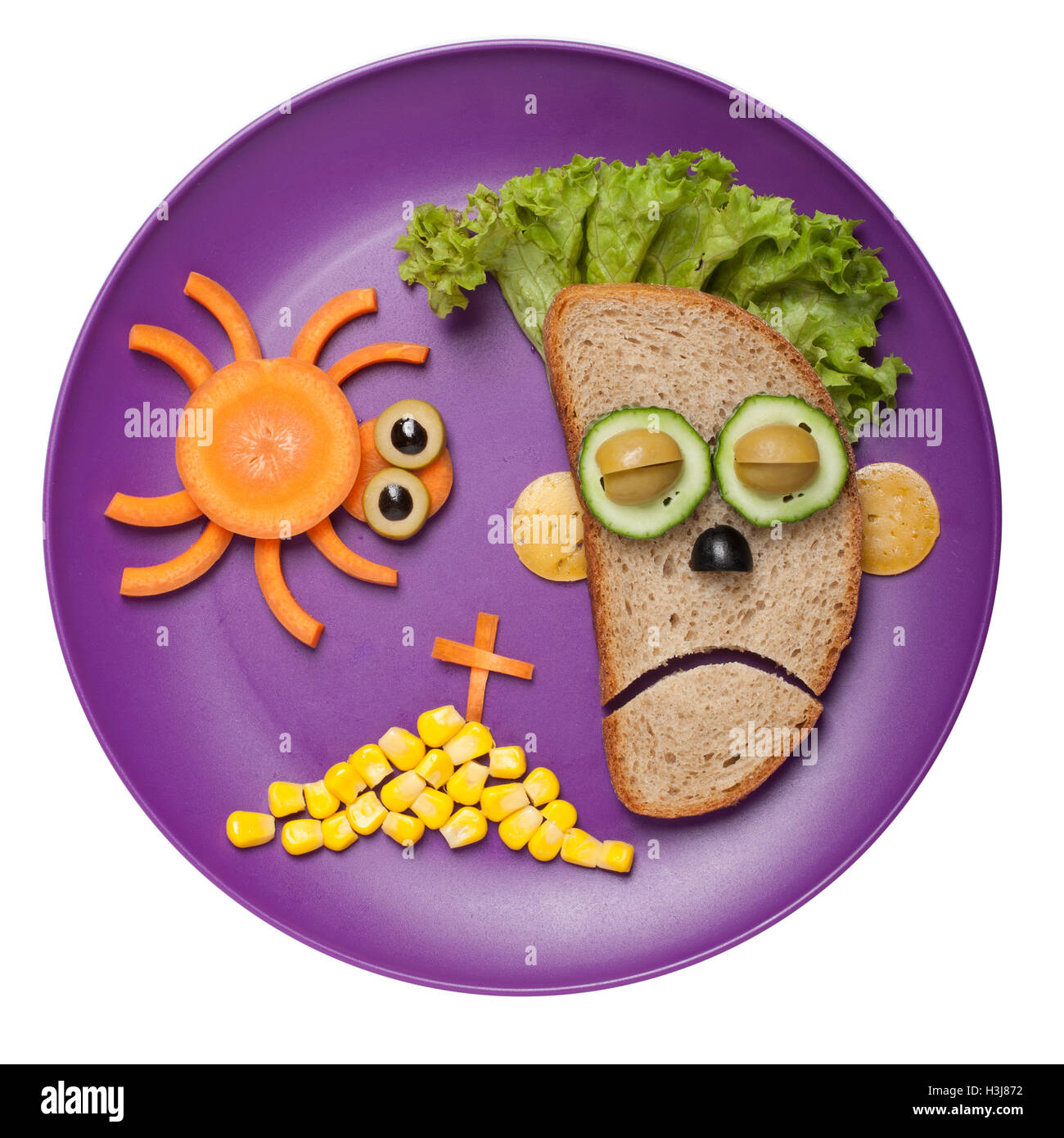 Halloween zombie and spider made of bread vegetables on plate Stock Photo
