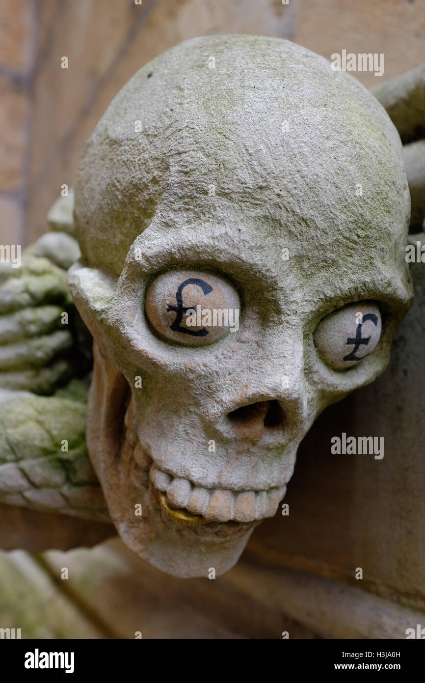A modern grotesque (stone carving) on Lincoln Cathedral symbolising greed Stock Photo