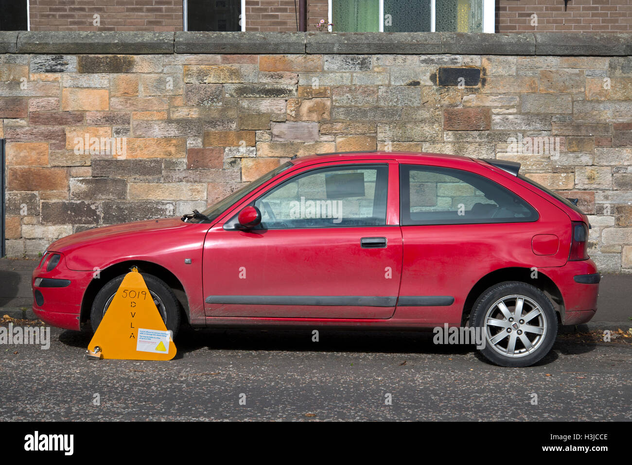 Untaxed car clamped by the DVLA Stock Photo Alamy
