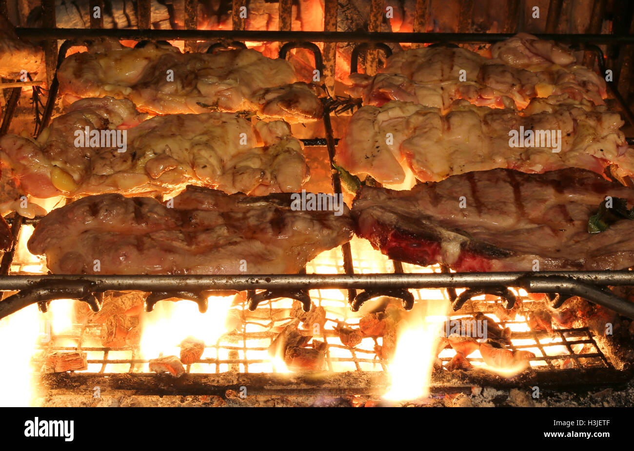 tasty chicken meat cooked barbecued in the  fireplace in the restaurant Stock Photo