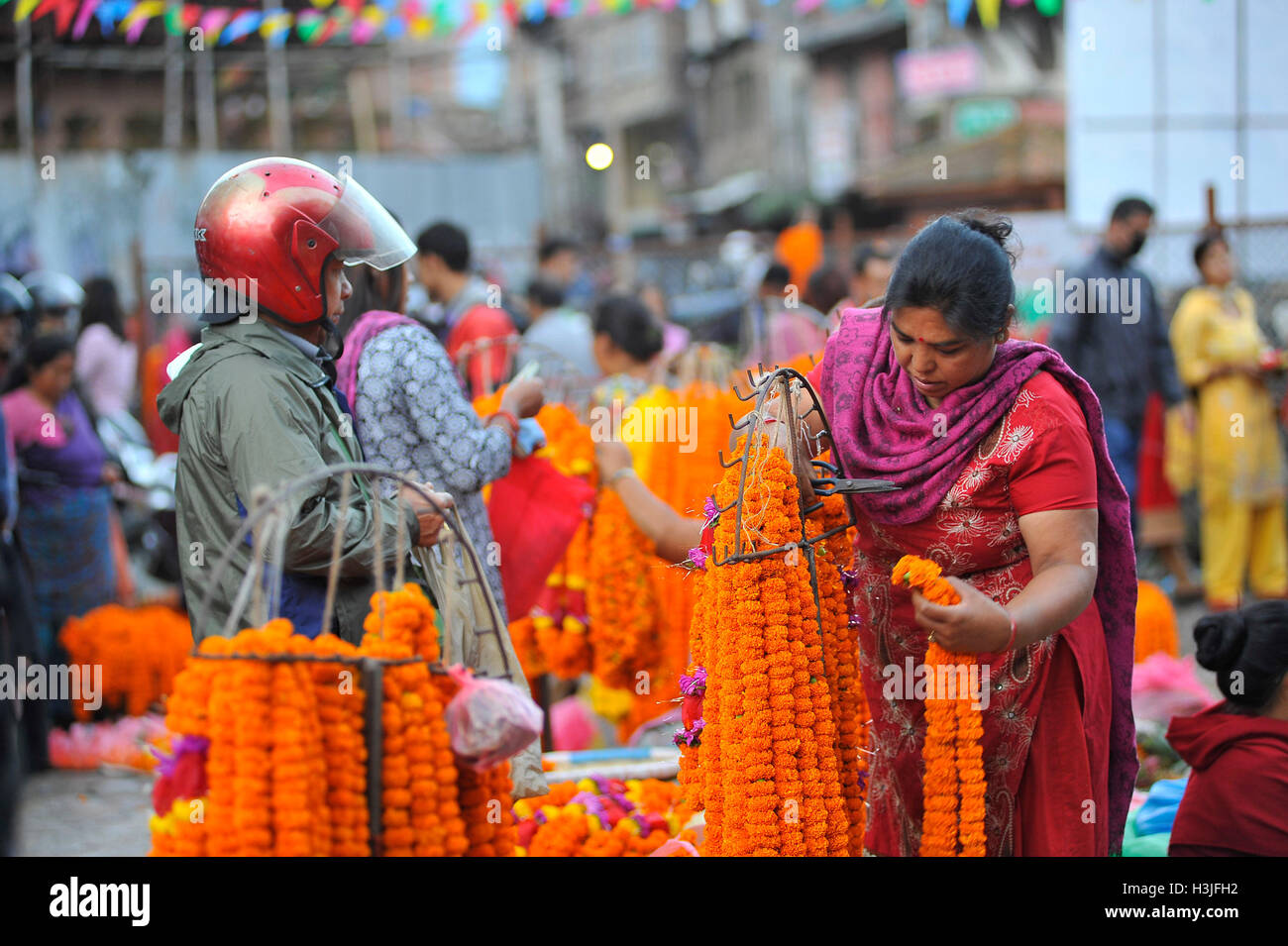Kathmandu, Nepal. 10th Oct, 2016. Devotee buying flower garlands on the