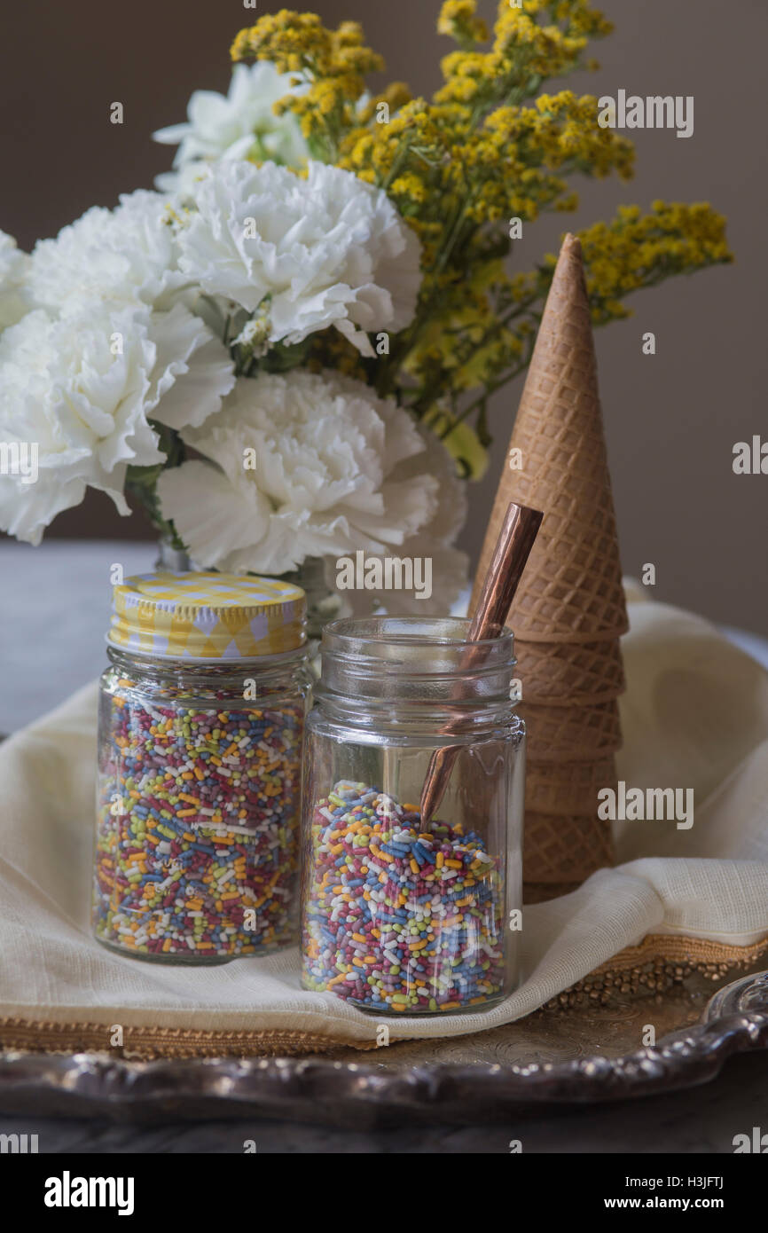 Ice Cream Cones and sprinkles, with flowers Stock Photo