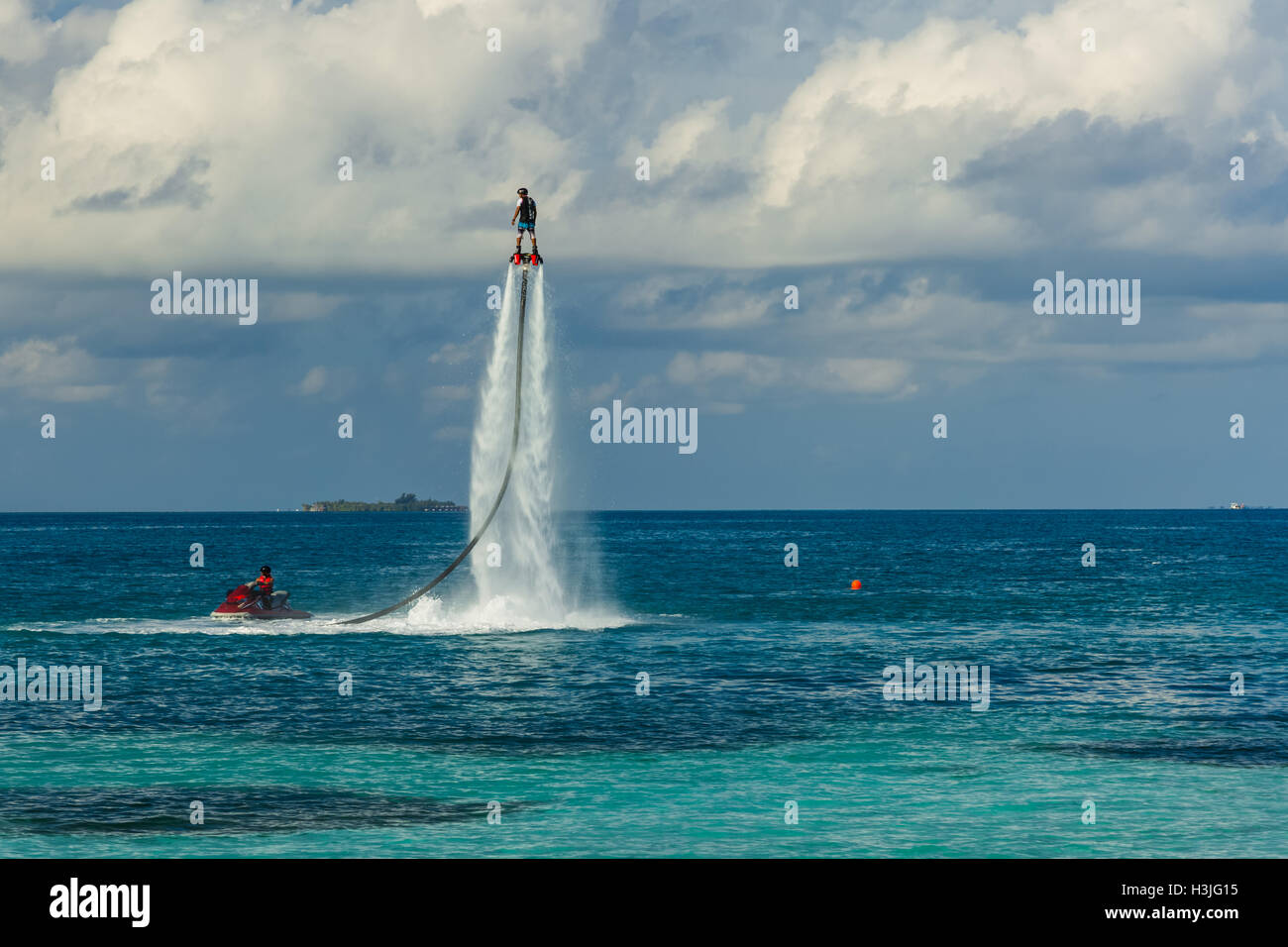 Flyboard Rider Silhouette of a fly board rider at sea. Professional rider do tricks in ...