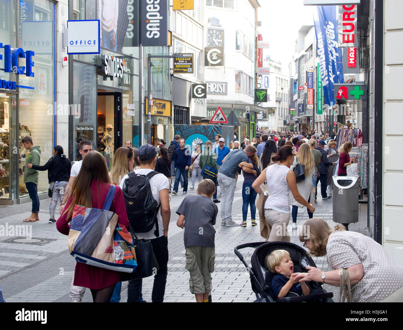 Busy shopping street with many people in the city center of Cologne
