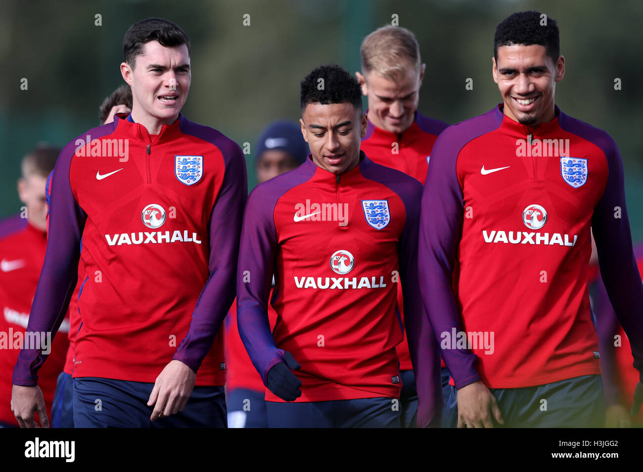 England's Michael Keane (L - R) England's Jesse Lingard and England's Chris Smalling during a training session at Enfield Training Ground, London. Stock Photo
