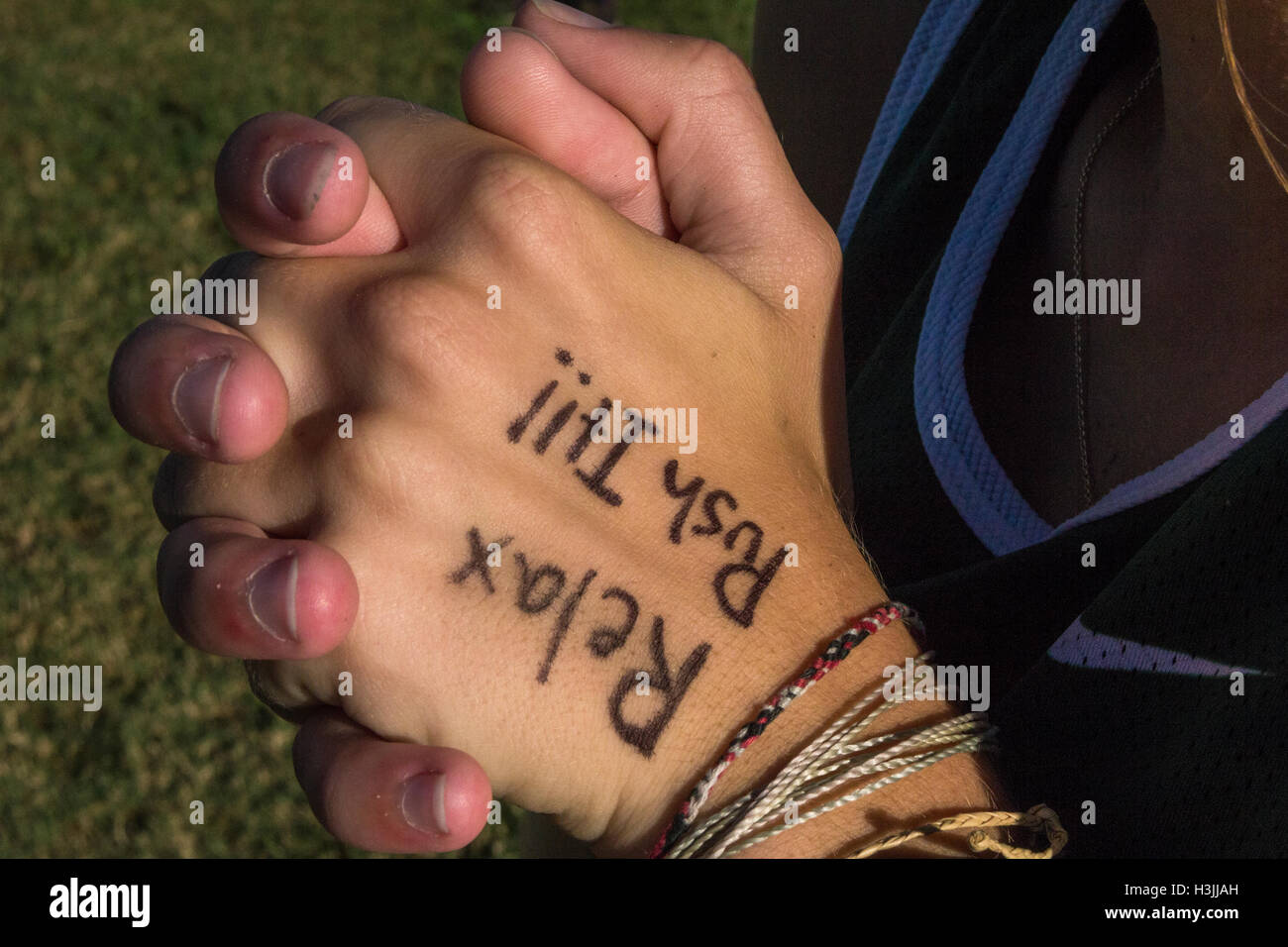 Youthful athletes running cross country with motivational quote written