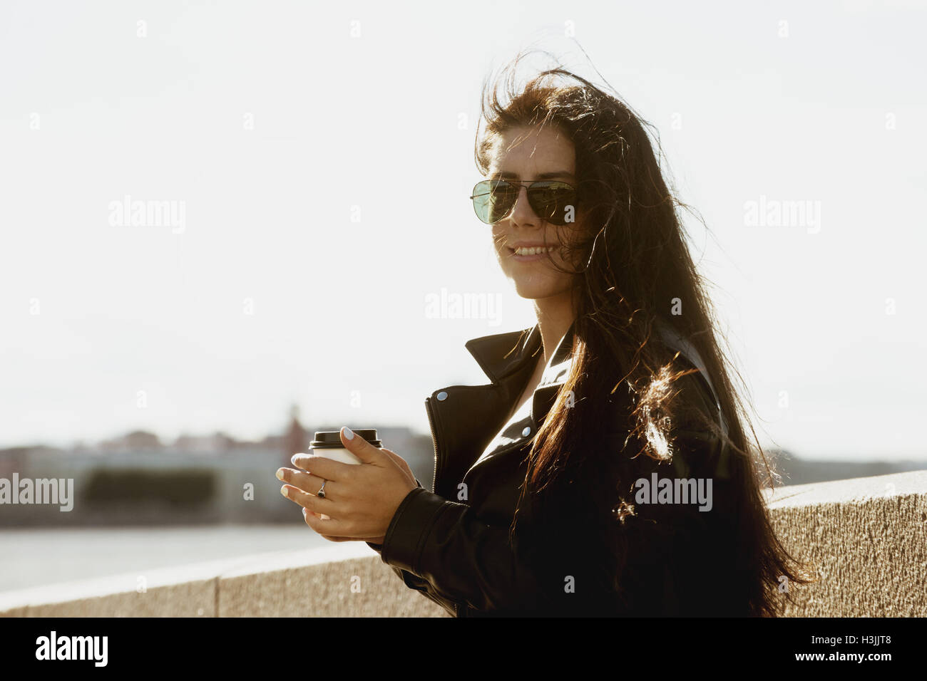 Girl with coffee on city background Stock Photo