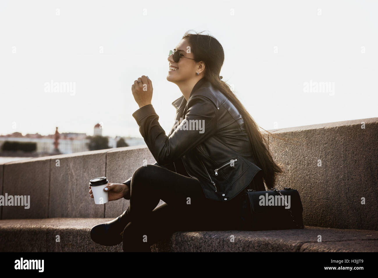 Girl with coffee to go in city Stock Photo